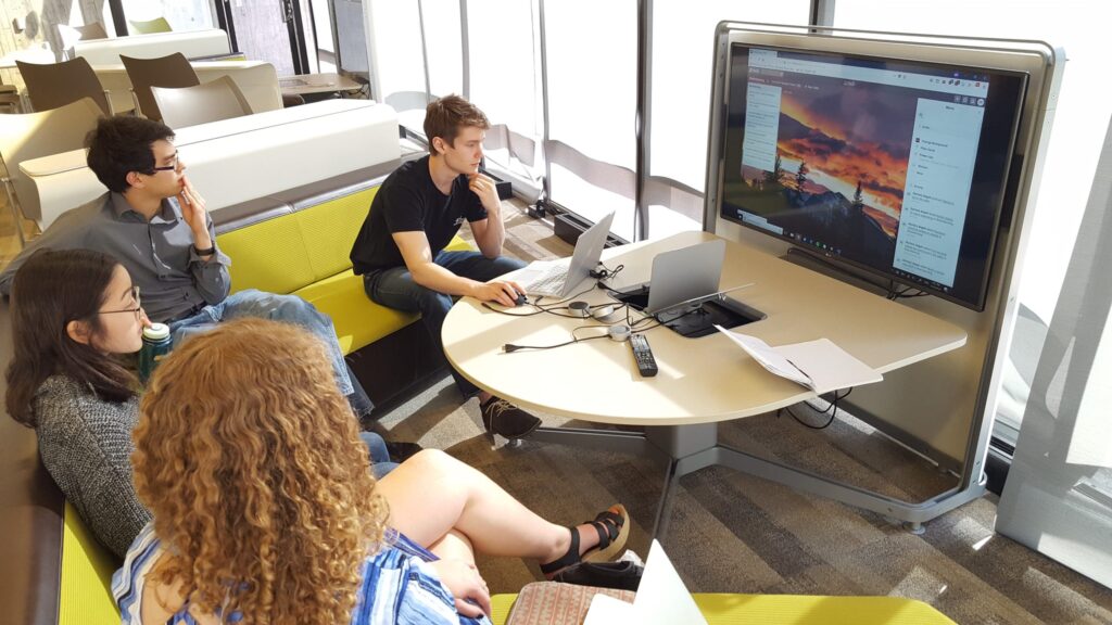 GCIEL student dev team members (clockwise around the table) Rachel Swoap ('19), Sam Nakahira ('19), Zachary Segall ('18), and Eli Most ('18) at the start of a two-week Scrum sprint.