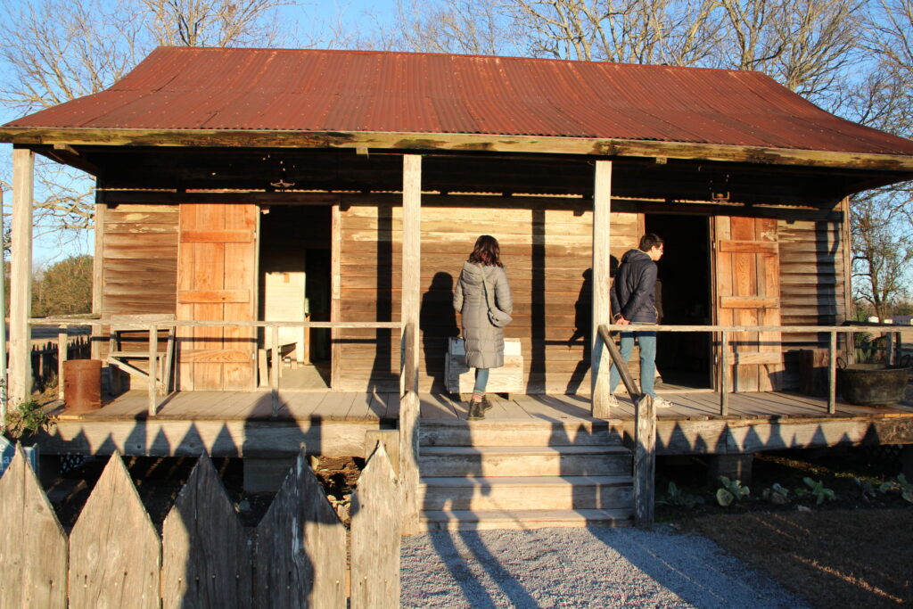 Field research. Members of the GCIEL student development team (from left to right: Sam Nakahira ('19) and Zachary Segall ('18)) conduct site-based research of a double-pen slave cabin at Laura Plantation in Vacherie, Louisiana (January 2018). Photo by David Neville.